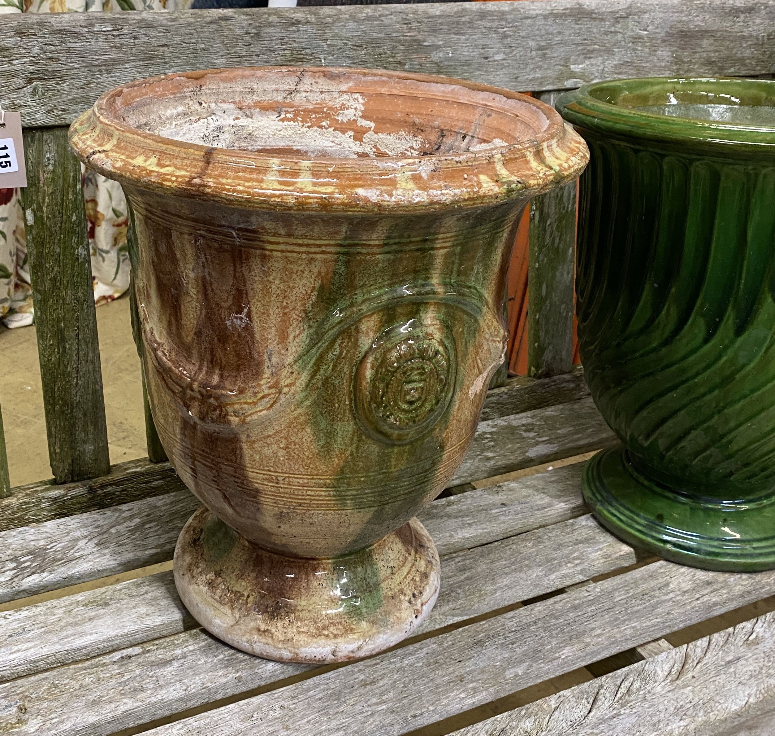 A reconstituted stone circular garden bird bath, diameter 40cm, height 67cm together with two garden planters